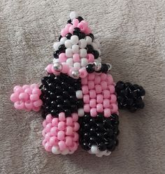 Kandi clown I made for my friend for Christmas!  Amount of beads used: 154 Pink - 74 white - 157 Black - 8 silver Tutorial is linked Kandi Christmas Tree, Kandi Dragon, Christmas Kandi Bracelets, Christmas Kandi, Kandi Core, Kandi Tutorial, Kandi Cuff Patterns, Bracelet Stuff, Kandi Ideas