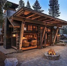 an outdoor living area with a fire pit and covered patio in the middle of it