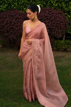 Pink saree, featuring long cascading hem, hand embroidered floral motifs on border. Comes with an unstitched blouse piece.
Components:2
Embroidered
Neckline:
Sleeve Length:
Fabric:Organza Satin Silk
Color:Pink
Hand embroidered border on saree
Note: The blouse worn by the model is for styling purpose only - Aza Fashions Saree Inspo For Wedding, Elegant Saree For Wedding, Silk Saree Outfit Ideas, Festive Saree Look, Saree In Wedding, Fancy Sarees Wedding Reception, Simple Elegant Saree, Pink Saree Wedding, Saree Look Traditional