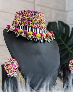 a black mannequin with colorful beads on it