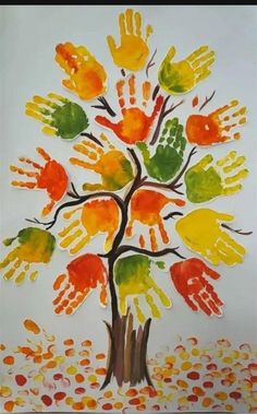 an art project with handprints on paper and watercolor paint, in the shape of a tree