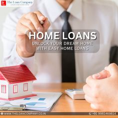 a man holding a house with the words home loan in front of him and another person sitting at a desk