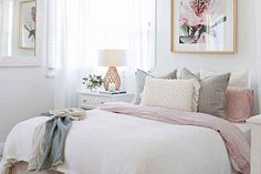 a bedroom with white walls and pink accents