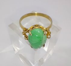 Elaborate vintage 14ct gold and carved green jade ring Perfect condition  Marked 585 for 14ct gold The front of the ring measures 1.4cm at the widest point and sits at 0.8cm off the finger  UK ring size T, US size 9 1/2 Green Carved Rings For Formal Occasions, Formal Carved Green Ring, Formal Green Carved Ring, Vintage Carved Green Ring, Vintage Green Carved Ring, Jade Ring, Jade Green, Rings Statement, Vintage Rings