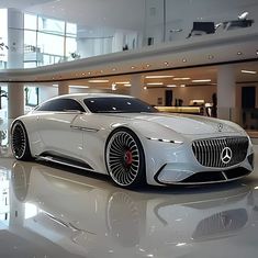 the mercedes concept car is on display at an event in a large room with high ceilings