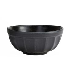 a black bowl sitting on top of a white table