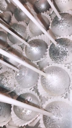 silver and white ornaments are arranged on top of each other