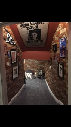 the hallway is decorated with brick walls and pictures on the wall, along with carpeted flooring