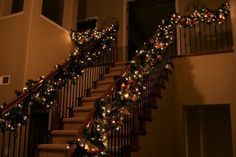 stairs decorated with christmas lights and garlands for the holiday decorations on each handrail