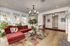 a living room filled with furniture and lots of windows