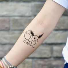 a woman's arm with a tattoo of a pokemon pikachu on it