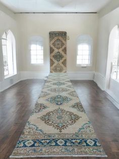 a long rug is in the middle of an empty room