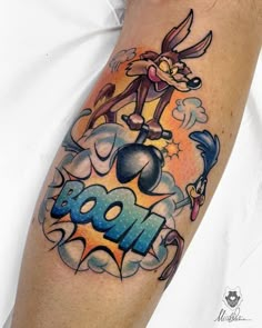 a cartoon tattoo on the arm of a man