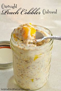 a spoon in a glass jar filled with oatmeal and orange peels