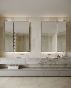 a bathroom with two sinks and three mirrors