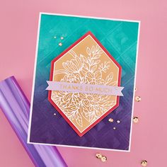 a close up of a greeting card on a pink surface with confetti around it