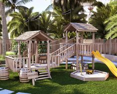 a wooden play set in the grass next to a yellow slide and some barrels with water