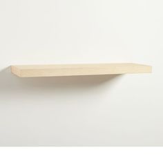 a wooden shelf on the wall with no one around it or in front of it