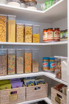 an organized pantry filled with cereal, pasta and other food items in containers on shelves