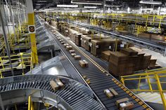 an assembly line with boxes on the conveyor belt and stairs leading up to them