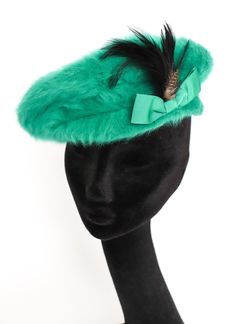 JUST AMAZING! This Kangol sea green angora fur beret took my breath away on trying it on.  Yes, the colour and feathers are striking but ist is the structure that i marvelled at. Although it is a simople beret it sits on the head like an elegant structured hat. WORTH EVERY PENNY! Made in ENGLAND A bit of history.... This hat was purchased as part of the extensive wardrobe belonging to an astute woman of fashion (I call her Leopard Lady as she loved leopard print) who lived to 100 years. Her daughter informed me that up until the age of 70 she always wore heels, hats and a handbag and was recognized and admired in her local high street in the Midlands. The collection purchased includes coats, blouses, dresses, bags, hats and shoes all listed for sale. Size: M/L Approximate Inner Measurement Hat Beret, Green Hat, Green Hats, Sea Green, Just Amazing, Hats Vintage, Call Her, 100 Years, Festival Season