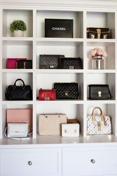 many different purses and handbags are on display in a white shelving unit