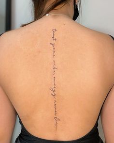 the back of a woman's neck with writing on her left shoulder and right arm