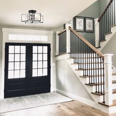 an empty entryway with stairs leading up to the second floor and two doors on either side