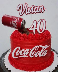 a coca cola cake with the number forty on it and a coke can atop top