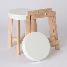 three wooden stools and one white stool