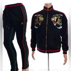 Men’s Makobi Decorative Lion Patch Fleece Track Suit-Black/Green/Red Fleece Track Jacket Has Decorative Embroidered Lion Patch Has Silver, Beige, And Red Threading Lion Patch Has Rhinestones Embedded In Its Intricate Design Heavy Duty Soft Thick Fleece Material Not Only Looks Good But Feels Good Too Track Suit Has Green And Red Striping On The Sleeves Ribbing At Cuffs, Collar, And Waistband 2 Pocket Design Has Gold Zippers And Velvety Smooth Feel Fitted Black Tracksuit For Winter, Gucci T Shirt, Suit Black, Red Fleece, Fashion Suits For Men, Track Suit, Pullover Designs, Green And Red, Gold Zipper