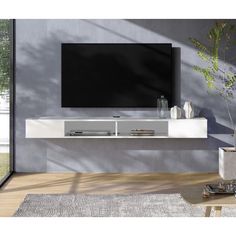 a living room with a large tv mounted on the wall