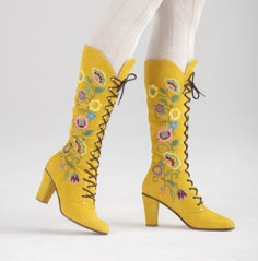 The most beautiful handmade suede embroidered boots in the 1960s Jerry Edouard vintage "Almost Famous" style. In mustard suede. Has a scroll of embroidered flowers and leaves made of multicolored orange, yellow, blue, green, purple, and pink thread on both sides of the boot. Have blue and yellow beading on the flowers. Lace all the way up in fine chrome eyes and hooks. Tapered toe and Cuban heel.  Have brown braided laces. Have padded insoles for comfort and an all-leather lining. Condition: new Composition: suede upper, leather interior, embroidery, beads, manmade sole   Size 36 Dimensions: Length of insole: 9.6" or 242 mm Width of insole: 2.8" or 71 mm Height: 16.5" or 419 mm Heel height: 3.2" or 78 mm Calf circumference: 11.25" or 281 mm to 13.5" or 343 mm Size 37 Dimensions: Length of 60s Boots, 70s Shoes, Go Go Boots, Pink Thread, Yellow Boots, 1960s Style, Embroidery Beads, 70s Inspired Fashion, Embroidered Boots