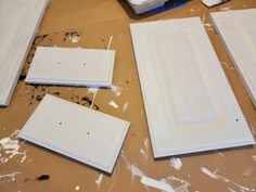 three pieces of white painted wood sitting on top of a table