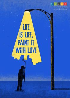 a man holding a sign that says life is like paint it with love