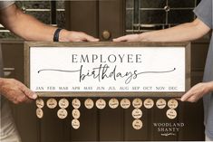 two people holding up a sign that says employee birthdays with words on the front