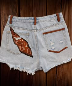 Handpainted/ Denim Shorts. Bandana design.  It is a one-off statement piece.  *Note : Size MEDIUM **How to take care of your handpainted garments:  Hand wash (recommended) or machine wash up to  30◦ C (104F). For a longer durability, turn the garment inside out.    Turn the garments inside out while ironing or use a piece of cloth between the painting & the iron.    Machine drying is not recommended  Please, feel free to message me any questions you may have. I will be glad to answer them, as soon as possible. Thank you for spending time in my shop :) I really appreciate it. Sending love and positive energy, Anna Jean Shorts Painting Ideas, Trendy Cutoff Jeans For Festival, Casual Cutoff Jeans For Festival, Hippie Style Jeans For Summer Festival, Summer Festival Hippie Jeans, Relaxed Fit Jeans For Summer Festival, Bohemian Jeans For Summer Festivals, Summer Bohemian Festival Jeans, Bohemian Summer Festival Jeans