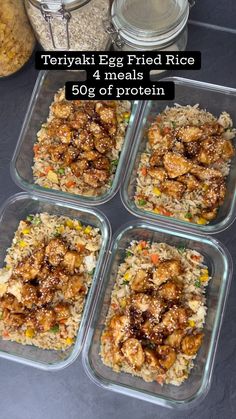 four plastic containers filled with food on top of a black counter next to rice and other foods