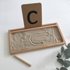 a sand tray with a letter c on it