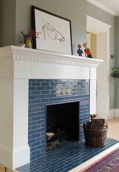 a living room with a fireplace and pictures on the wall