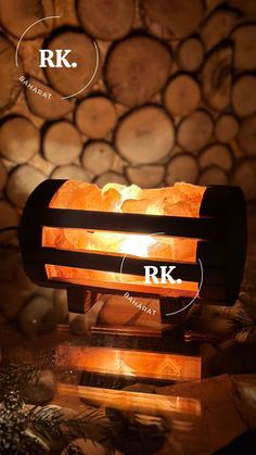 a light that is sitting on top of a wooden table with logs in the background