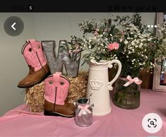 a table topped with boots and vases filled with flowers