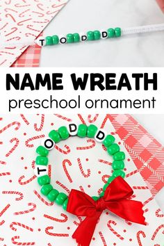 the name wreath preschool ornament is made with green beads and red ribbon