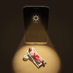 a cell phone sitting on top of a table next to a baby in a sunbath