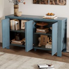 a blue cabinet with books and vases on top