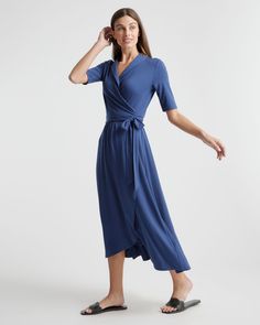 Fitted where you want it, flowy where it feels good. Our Tencel Jersey Midi Wrap Dress is the timeless classic everyone needs in their lineup. Eco-cool and all-day comfy with a rounded collar and modern midi length, it’s as soft as it is sustainable, and it’s part of our growing knit-dress collection. Also offered in sizes 1X-3X.  | Quince | Women's Tencel Jersey Midi Wrap Dress in Navy, Size XL Quince Blue, Wrap Dress Midi, Jersey Wrap Dress, Midi Wrap Dress, Dress Out, High Quality Dress, Perfect Wedding Dress, Elbow Length Sleeve, Quince