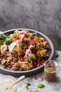 a bowl filled with cauliflower and pomegranate