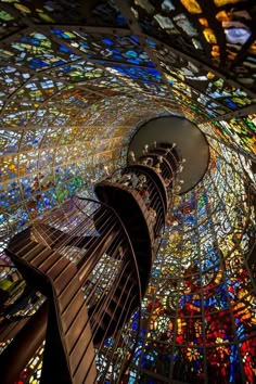 the inside of a building with many stained glass windows