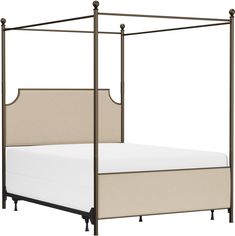 a bed with four posts and a white sheet on it's bottom half is shown