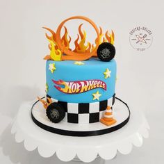 a blue cake with flames and wheels on top